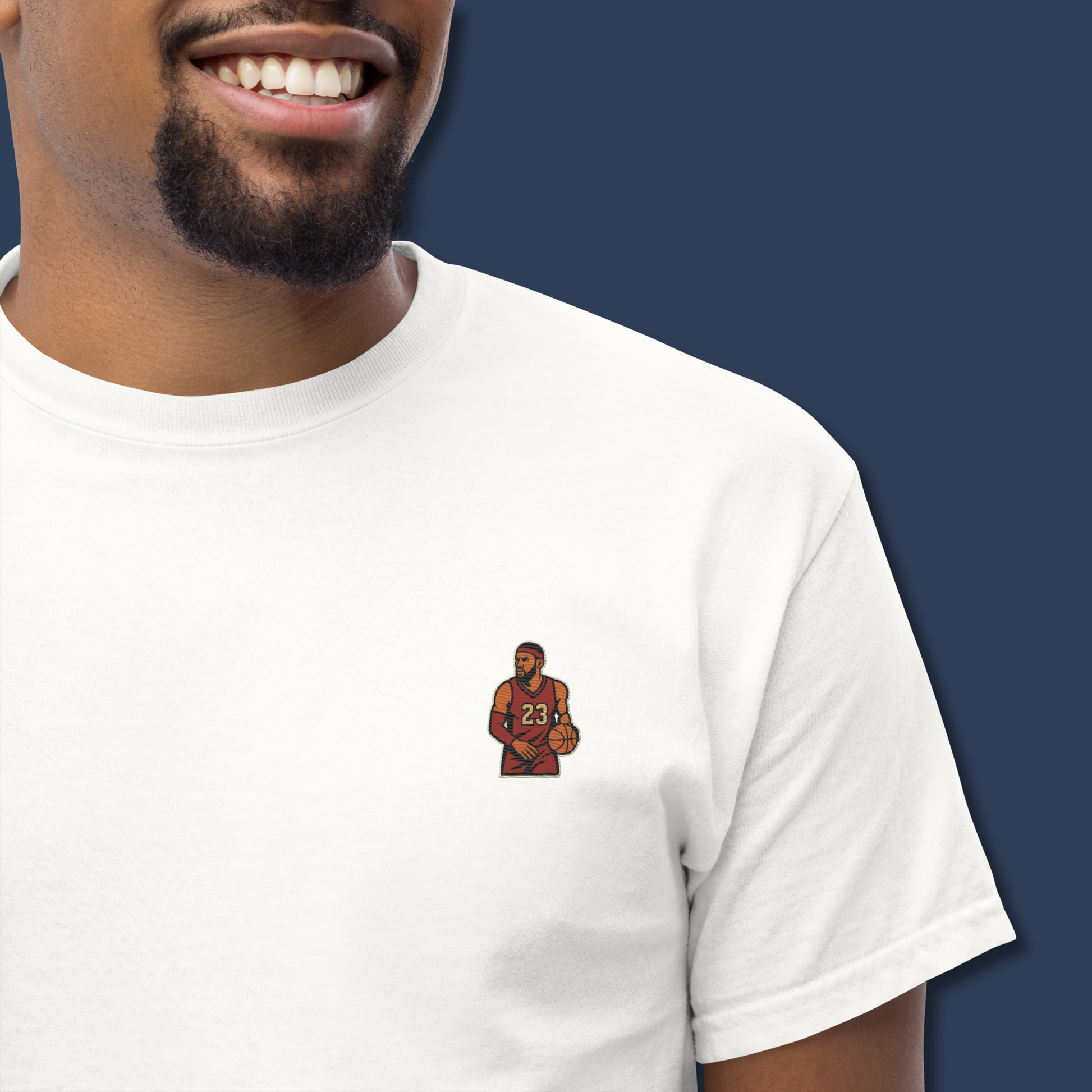 Men's (or Unisex) white cotton t-shirt featuring a small, vintage-inspired embroidered patch/graphic of NBA basketball player LeBron James in his L.A. Lakers jersey (number 23). Graphic tees, gift for him, retro style, Strength and Courage brand.