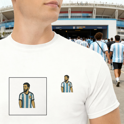 Men's (or Unisex)  cotton graphic tee featuring a small, retro-inspired embroidered patch/graphic of football player Lionel Messi in the Argentina (AFA) 'Albiceleste' jersey. GOAT, soccer, football, vintage style, Strength and Courage brand.