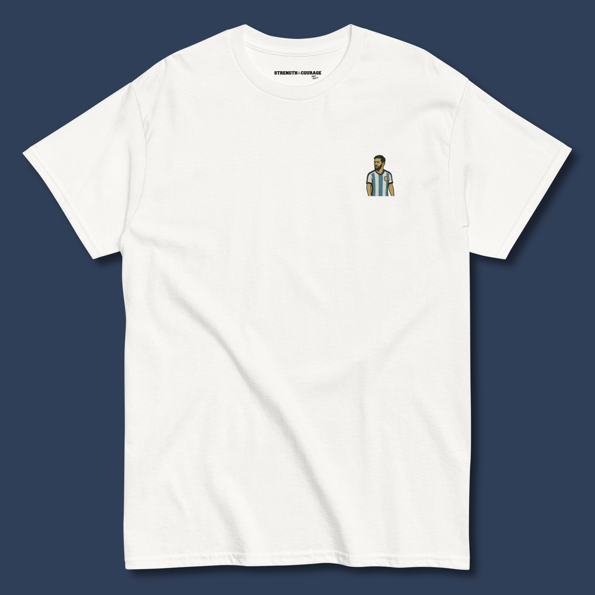 Men's (or Unisex) white cotton graphic tee featuring a small, retro-inspired embroidered patch/graphic of football player Lionel Messi in the Argentina (AFA) 'Albiceleste' jersey. GOAT, soccer, football, vintage style, Strength and Courage brand.