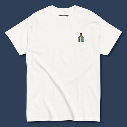 Men's (or Unisex) white cotton graphic tee featuring a small, retro-inspired embroidered patch/graphic of football player Lionel Messi in the Argentina (AFA) 'Albiceleste' jersey. GOAT, soccer, football, vintage style, Strength and Courage brand.