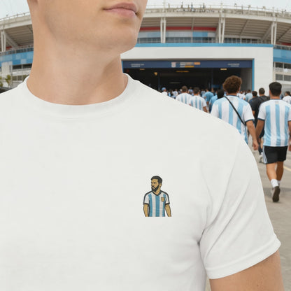 Men's (or Unisex) white cotton graphic tee featuring a small, retro-inspired embroidered patch/graphic of football player Lionel Messi in the Argentina (AFA) 'Albiceleste' jersey. GOAT, soccer, football, vintage style, Strength and Courage brand.
