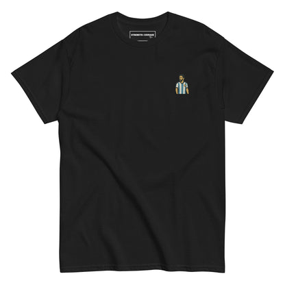 Men's (or Unisex) cotton graphic tee featuring a small, retro-inspired embroidered patch/graphic of football player Lionel Messi in the Argentina (AFA) 'Albiceleste' jersey. GOAT, soccer, football, vintage style, Strength and Courage brand.