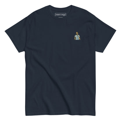 Men's (or Unisex)  cotton graphic tee featuring a small, retro-inspired embroidered patch/graphic of football player Lionel Messi in the Argentina (AFA) 'Albiceleste' jersey. GOAT, soccer, football, vintage style, Strength and Courage brand.