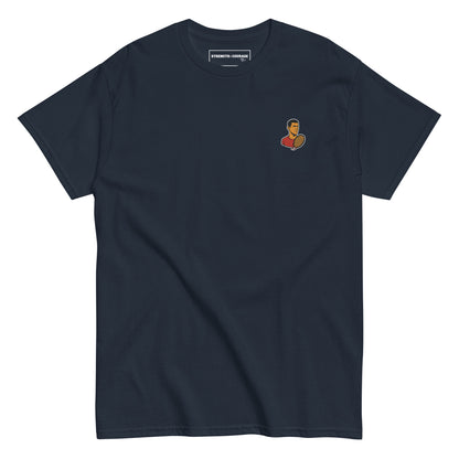 Blue navy cotton short sleeve t-shirt featuring a small, minimalist embroidered graphic design of tennis player Novak Djokovic in a red shirt holding a racket.
